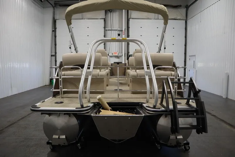 Slide: The Image of 2025 Bentley Pontoons 223 QSB Tri-Toon in a spacious indoor showroom. - 10