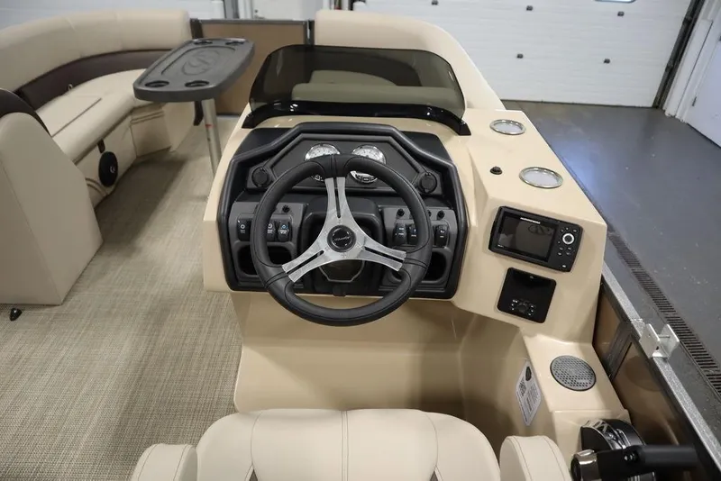 Slide: The Image of 2025 Bentley Pontoons 223 QSB Tri-Toon interior with steering wheel and control panel. - 17