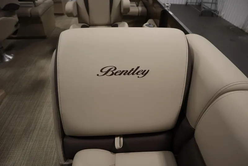 Slide: The Image of 2025 Bentley Pontoons 223 QSB Tri-Toon interior with beige seating and embroidered logo. - 19