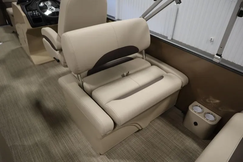 Slide: The Image of 2025 Bentley Pontoons 223 QSB Tri-Toon interior seating with beige upholstery and cup holders. - 3