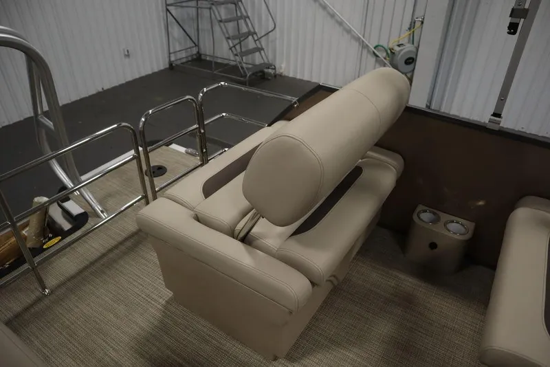 Slide: The Image of 2025 Bentley Pontoons 223 QSB Tri-Toon interior with beige seating and cup holders. - 39