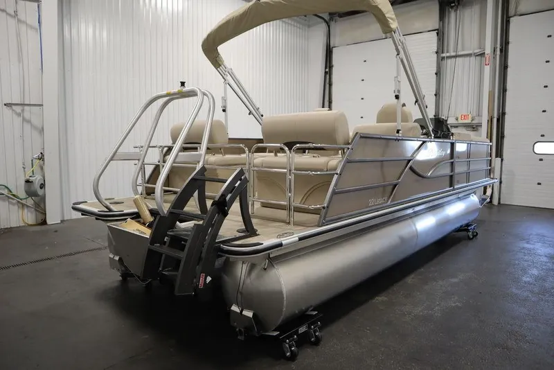 Slide: The Image of 2025 Bentley Pontoons 223 QSB Tri-Toon in a garage setting. - 4