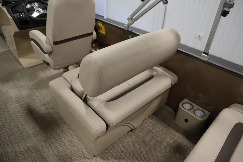 Slide: The Image of 2025 Bentley Pontoons 223 QSB Tri-Toon interior seating with beige upholstery and cup holders. - 43