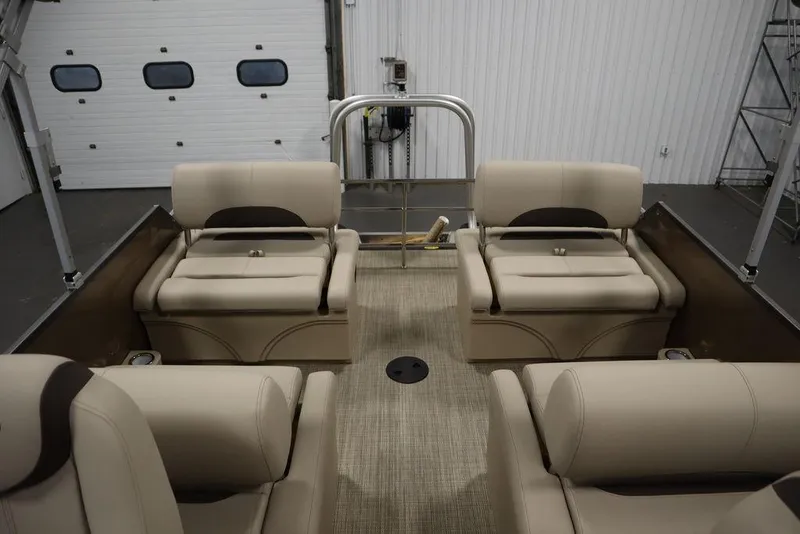 Slide: The Image of 2025 Bentley Pontoons 223 QSB Tri-Toon interior with beige seating in a showroom. - 46