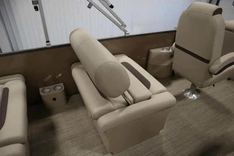 Slide: The Image of 2025 Bentley Pontoons 223 QSB Tri-Toon interior with beige seating and cup holders. - 47