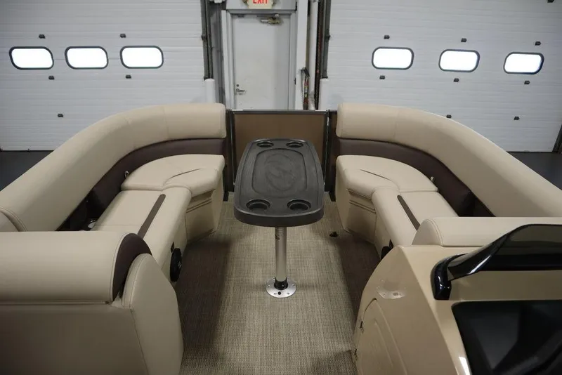 Slide: The Image of Interior of 2025 Bentley Pontoons 223 QSB Tri-Toon with plush seating and table. - 5