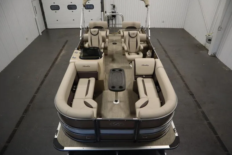 Slide: The Image of 2025 Bentley Pontoons 223 QSB Tri-Toon interior, spacious seating, luxury design in showroom. - 6