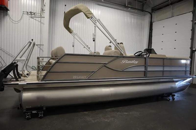 Slide: The Image of 2025 Bentley Pontoons 223 QSB Tri-Toon in a garage setting. - 7