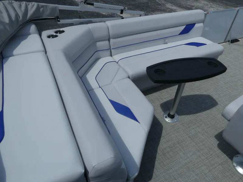 Slide: The Image of 2023 SunCatcher Select 20FC boat interior with cushioned seating and table. - 10