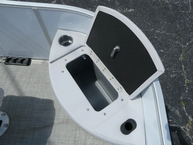 Slide: The Image of 2023 SunCatcher Select 20FC boat with open storage compartment and cup holder. - 5