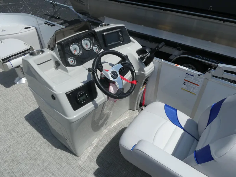 Slide: The Image of 2023 SunCatcher Select 20FC boat helm with steering wheel and control panel. - 7