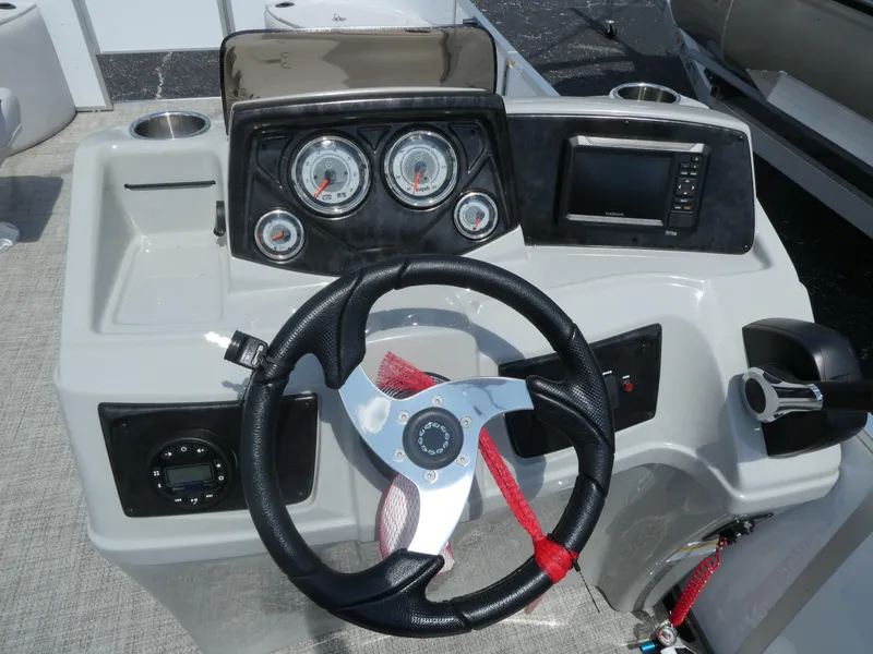 Slide: The Image of 2023 SunCatcher Select 20FC boat dashboard with steering wheel, gauges, and controls. - 8