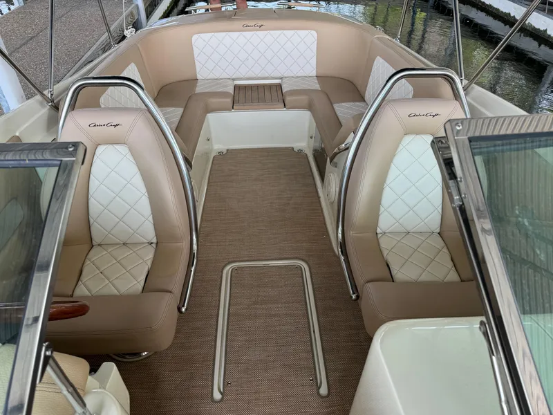 Slide: The Image of 2019 Chris-Craft Launch 27 interior with beige and white seating, elegant design. - 13