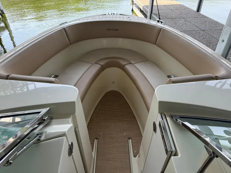 Slide: The Image of 2019 Chris-Craft Launch 27 boat interior with beige seating and open deck view. - 14