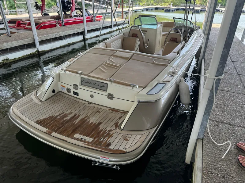 Slide: The Image of 2019 Chris-Craft Launch 27 boat docked, featuring elegant design and spacious seating. - 15