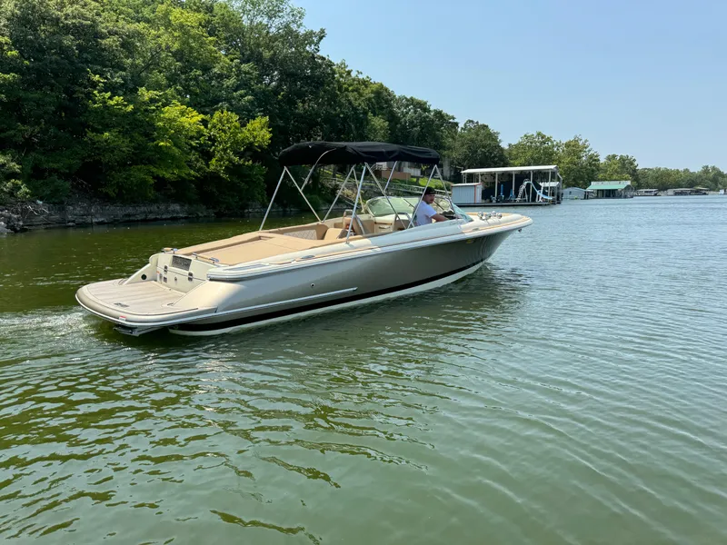 Slide: The Image of 2019 Chris-Craft Launch 27 boat cruising on a serene lake with lush greenery. - 4