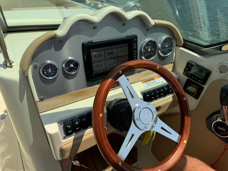 Slide: The Image of Dashboard of a 2019 Chris-Craft Launch 27 boat with wooden steering wheel. - 6