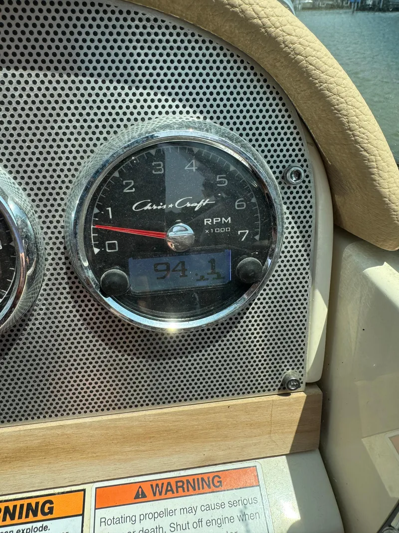Slide: The Image of 2019 Chris-Craft Launch 27 dashboard with RPM gauge and warning labels. - 7