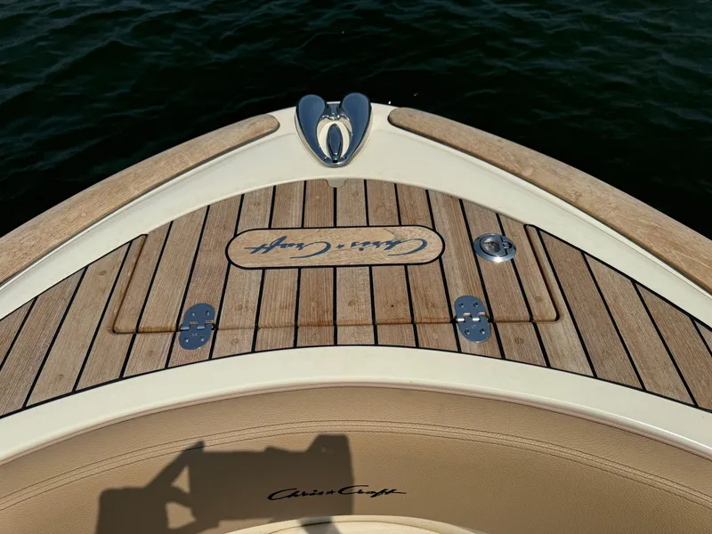 Slide: The Image of 2019 Chris-Craft Launch 27 boat deck with wood finish and logo detail. - 8