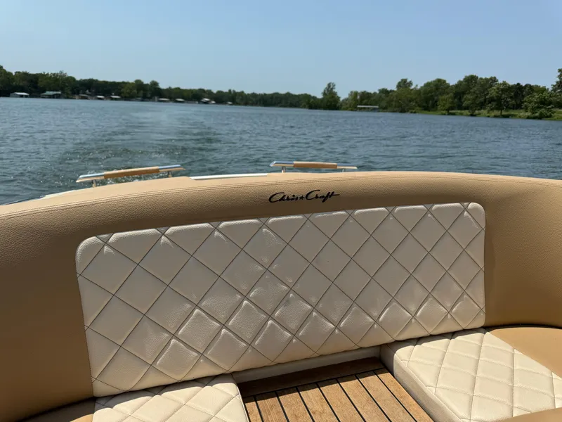 Slide: The Image of 2019 Chris-Craft Launch 27 boat interior with quilted seating on a serene lake. - 9
