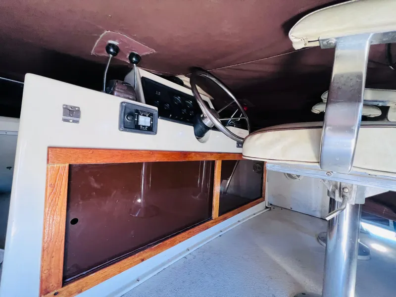 Slide: The Image of Interior of a 1982 Trojan F32 boat cockpit with steering wheel and controls. - 5