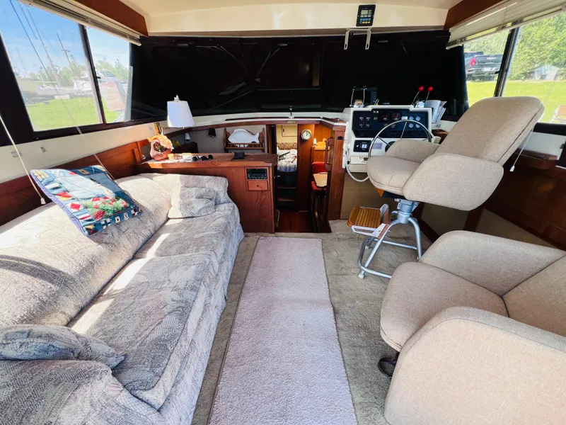 Slide: The Image of Interior of a 1982 Trojan F32 boat with cozy seating and helm station. - 6
