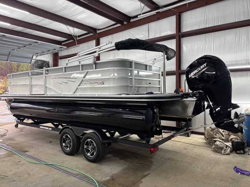 Slide: The Image of 2024 Ranger 220C pontoon boat with Mercury outboard in a garage setting. - 10