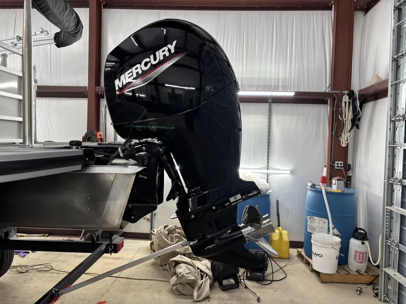 Slide: The Image of 2024 Ranger 220C boat with Mercury outboard motor in a garage setting. - 11