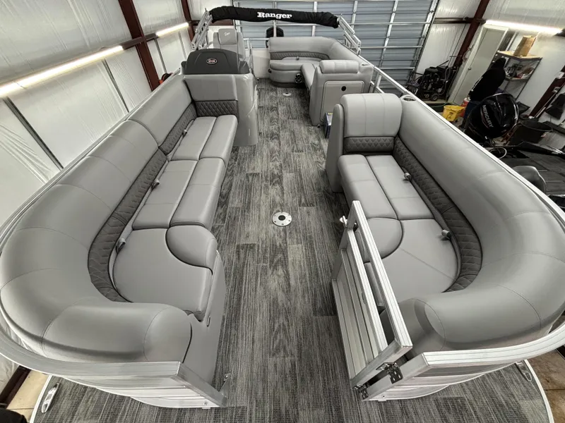 Slide: The Image of 2024 Ranger 220C pontoon boat interior with gray seating and spacious layout. - 12