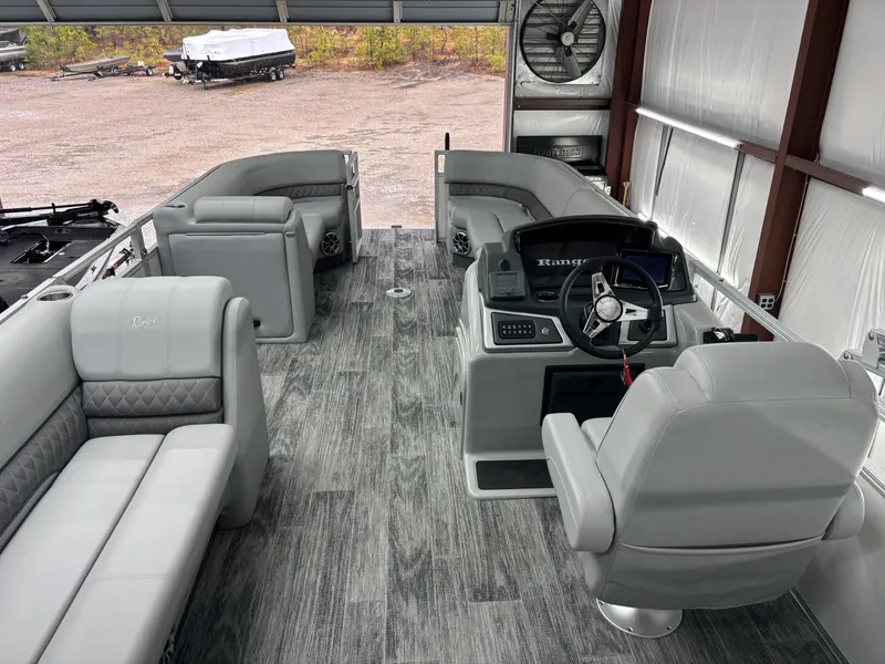Slide: The Image of 2024 Ranger 220C pontoon boat interior with gray seating and modern helm. - 14