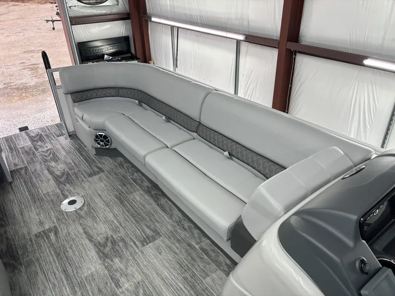 Slide: The Image of 2024 Ranger 220C boat interior with gray seating and wood-patterned flooring. - 16