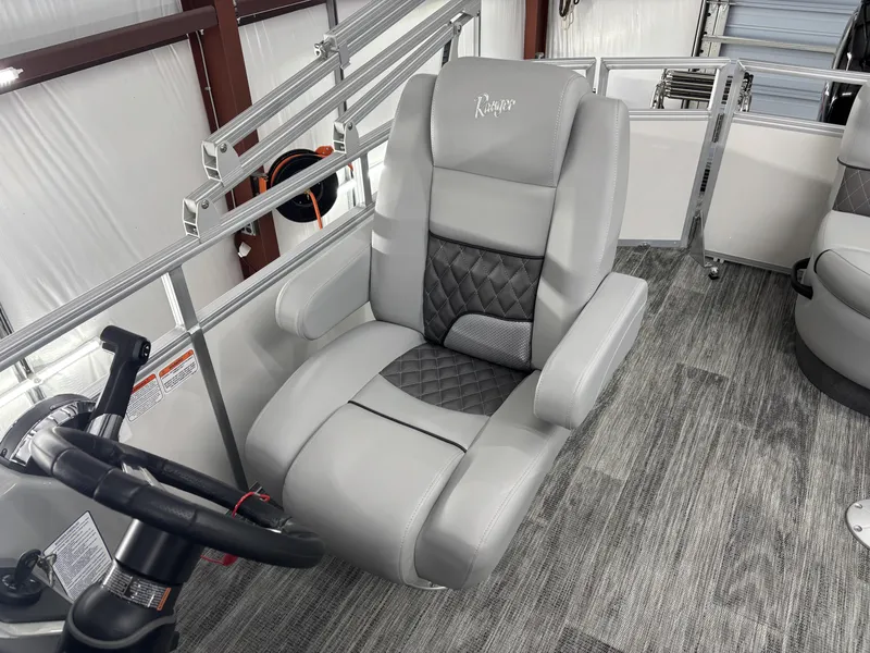 Slide: The Image of 2024 Ranger 220C boat interior with gray captain's chair and steering wheel. - 5