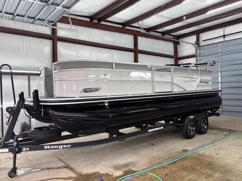 Slide: The Image of 2024 Ranger 220C pontoon boat on trailer in a garage setting. - 7