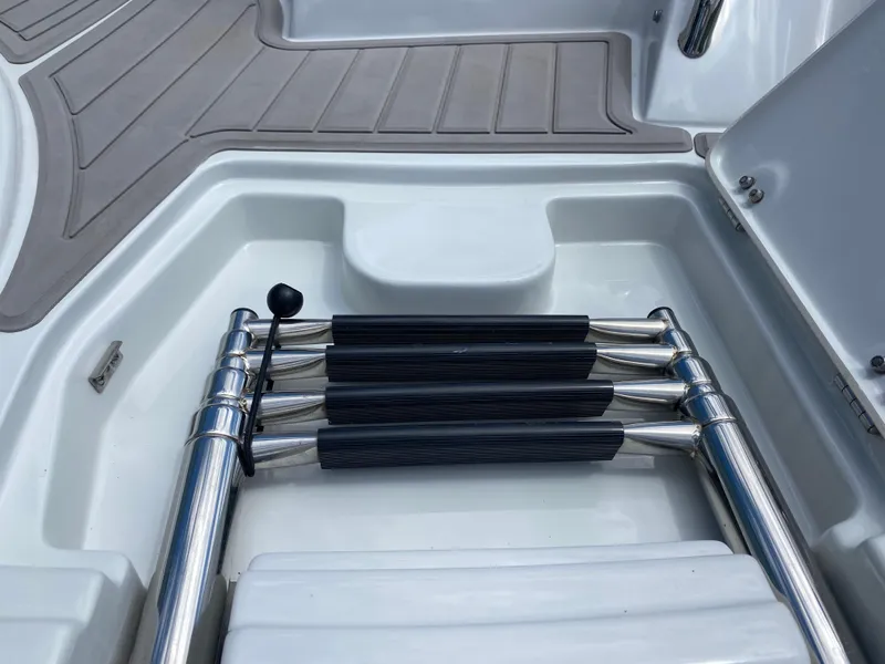 Slide: The Image of 2023 Crownline 280 XSS boat ladder in storage compartment. - 13