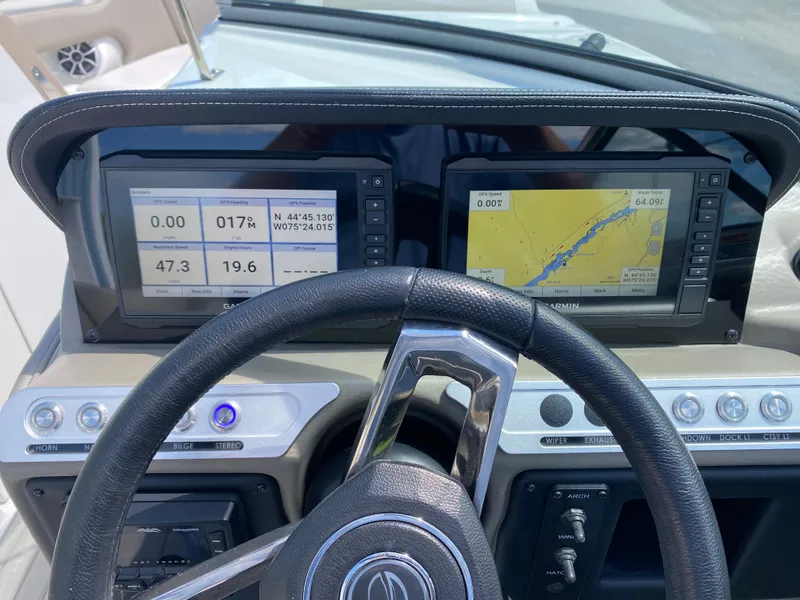 Slide: The Image of Dashboard of 2023 Crownline 280 XSS boat with navigation displays and steering wheel. - 17