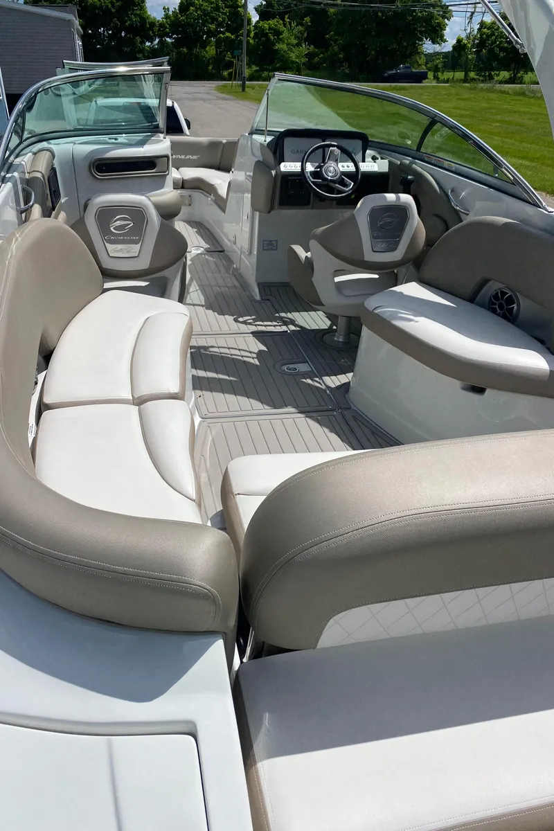Slide: The Image of 2023 Crownline 280 XSS boat interior with luxurious seating and modern dashboard. - 23