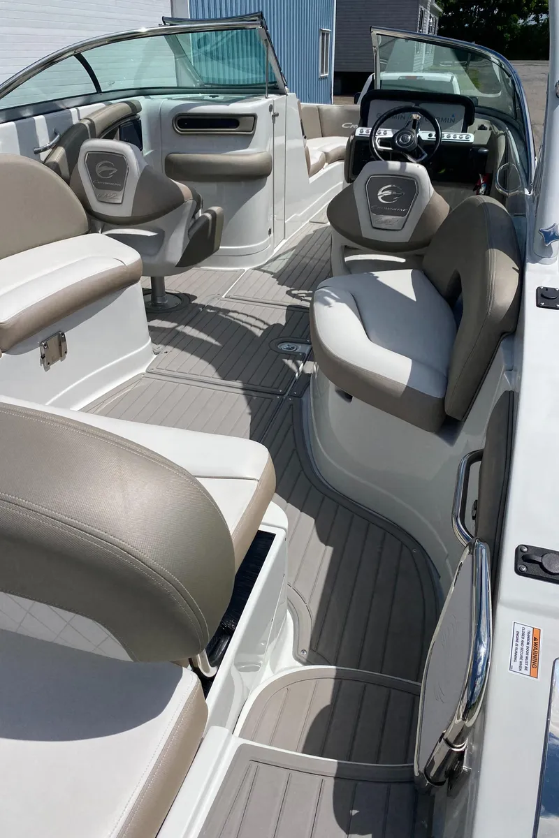 Slide: The Image of 2023 Crownline 280 XSS boat interior with beige seating and modern dashboard. - 24
