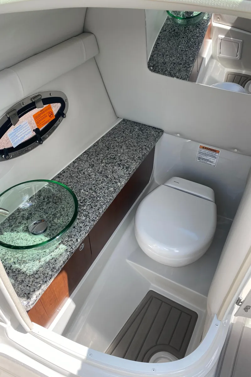 Slide: The Image of 2023 Crownline 280 XSS boat bathroom with granite countertop and modern fixtures. - 31