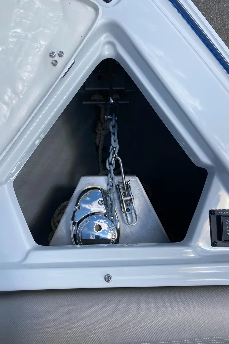 Slide: The Image of Anchor compartment of 2023 Crownline 280 XSS boat with chain and winch. - 35