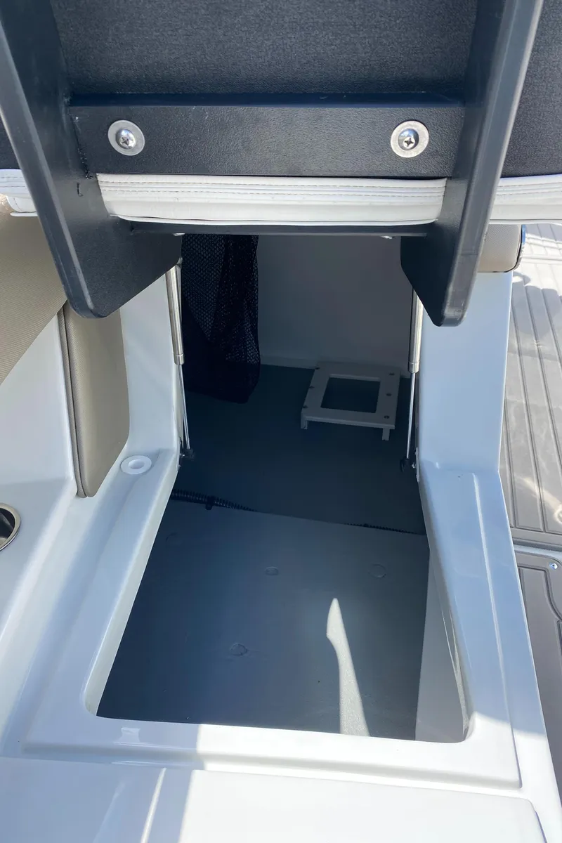 Slide: The Image of 2023 Crownline 280 XSS boat interior with open storage compartment. - 37