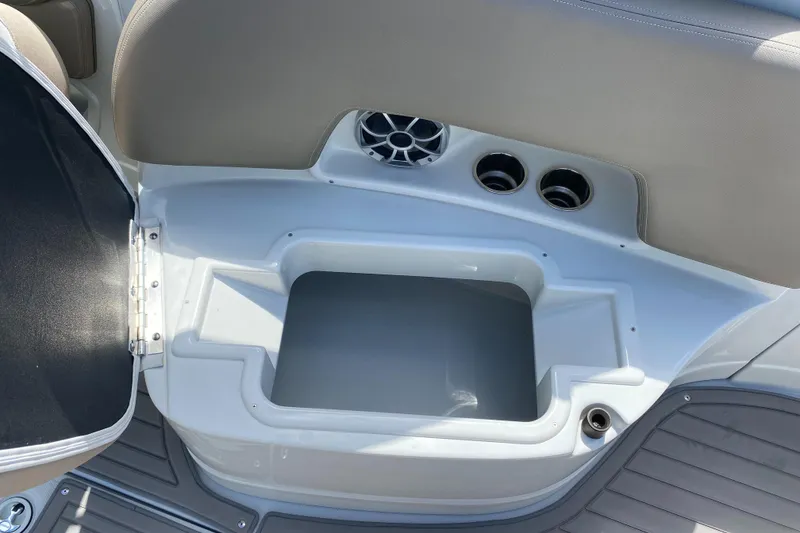 Slide: The Image of 2023 Crownline 280 XSS boat interior storage compartment with cup holders and speaker. - 41