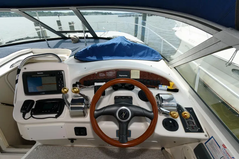 Slide: The Image of 1999 Sea Ray 340 Sundancer helm with navigation equipment and wooden steering wheel. - 5