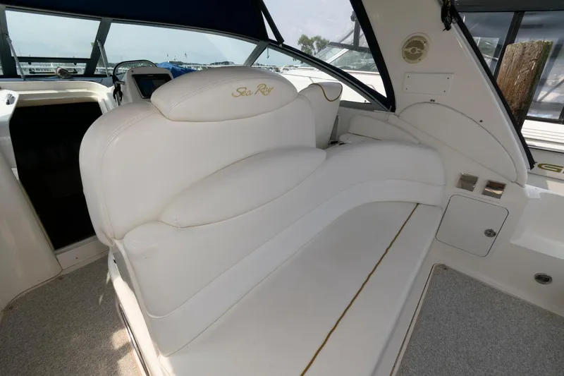 Slide: The Image of 1999 Sea Ray 340 Sundancer interior seating area with white upholstery. - 6