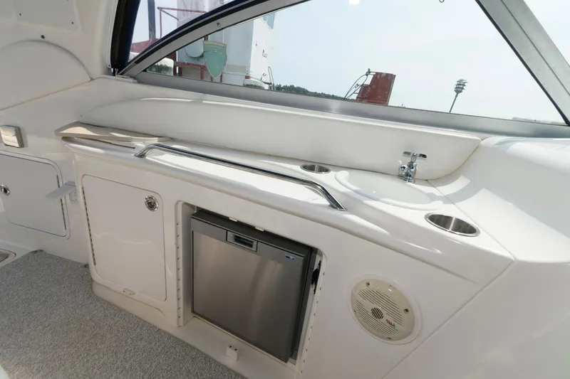 Slide: The Image of Interior of 1999 Sea Ray 340 Sundancer with sink, mini-fridge, and storage compartments. - 7