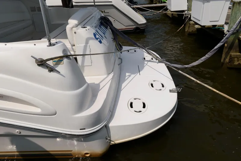 Slide: The Image of 1999 Sea Ray 340 Sundancer docked, rear view showing swim platform and mooring lines. - 8
