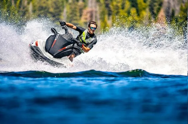 Slide: The Image of People launching a 2024 Kawasaki Waverunner Jet Ski STX from a trailer into a lake. - 4