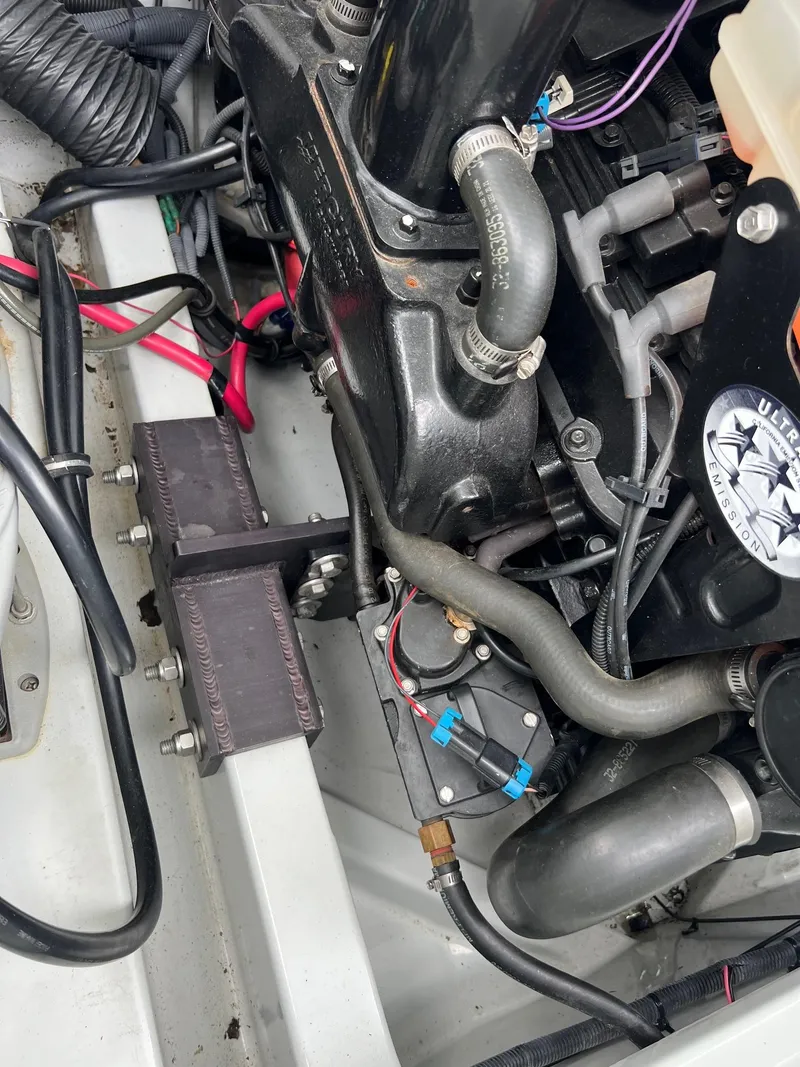 Slide: The Image of 2007 Baja Outlaw 260 engine compartment with visible hoses and wiring. - 12