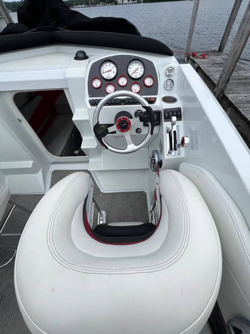 Slide: The Image of 2007 Baja Outlaw 260 boat cockpit with steering wheel and control panel. - 7