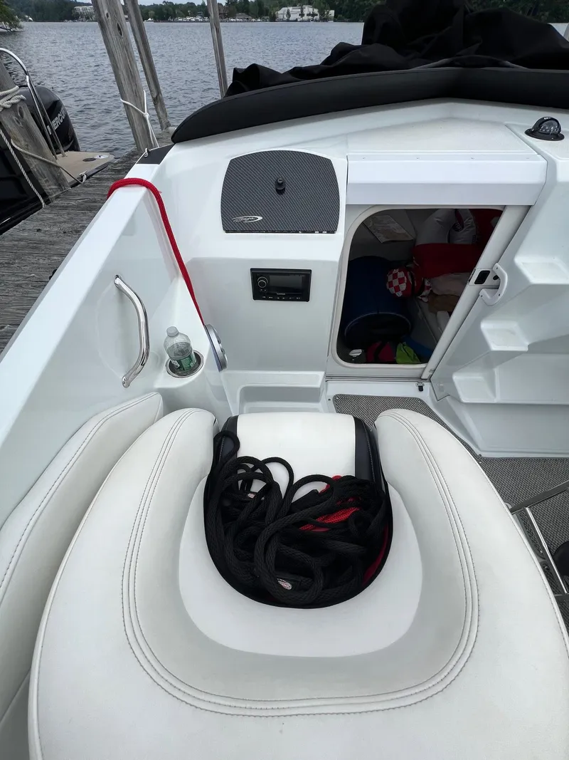 Slide: The Image of 2007 Baja Outlaw 260 boat interior with storage compartment and coiled rope. - 8