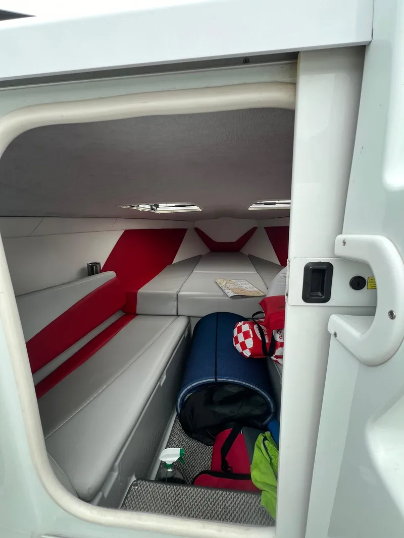 Slide: The Image of 2007 Baja Outlaw 260 cabin interior with red and white upholstery. - 9